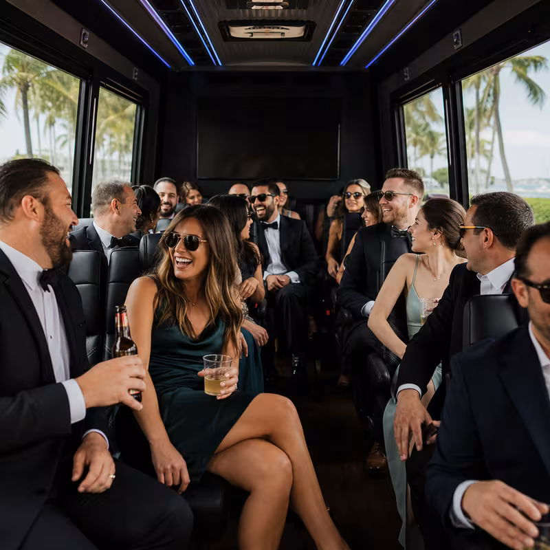 Wedding guests seated inside a Miami party bus