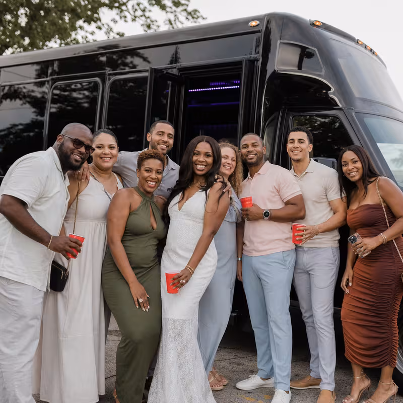 Group boarding a white charter bus for Birthday Transportation transportation in Miami