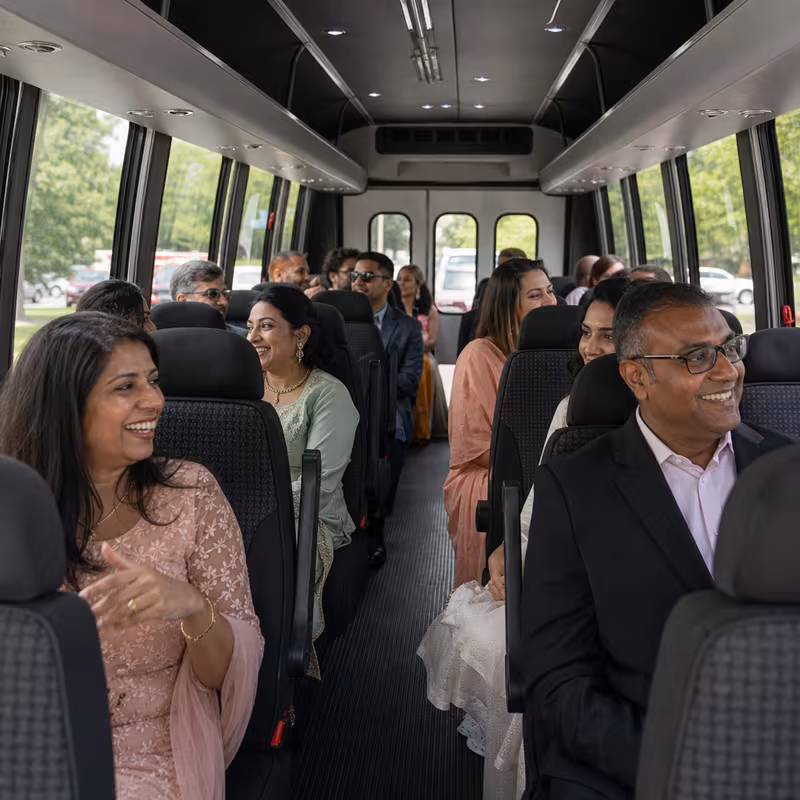 Group boarding a white charter bus for Private Event Transportation transportation in Miami