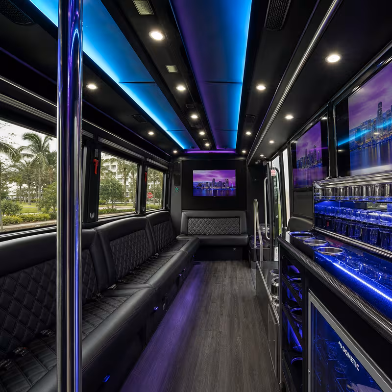 Party bus interior with wraparound leather seating and LED lighting in Miami