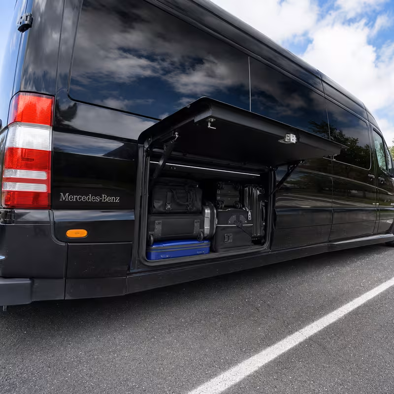 Party bus interior with wraparound leather seating and LED lighting in Miami