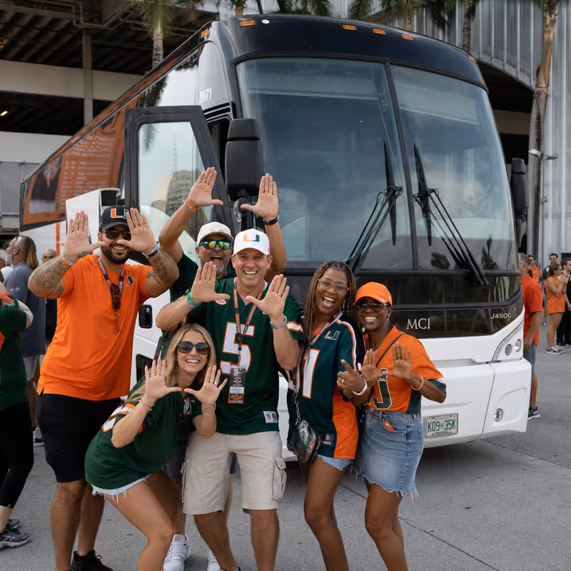 Passengers loading luggage while boarding an Miami group shuttle